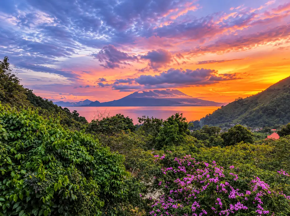 Sunset over Lake Atitlán and the volcanoes, seen from the hillside above Tzununa